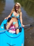 Madden shows her bikini body  while taking the kayak out on the river